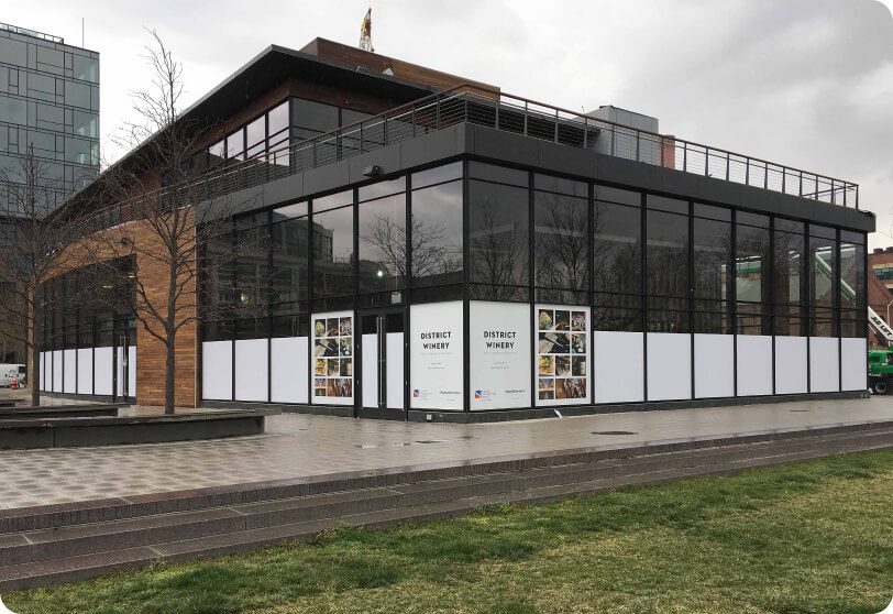 White privacy panels fitted across ground-floor storefront windows.