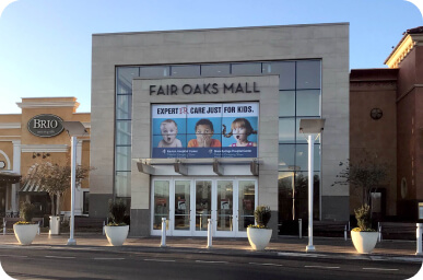Promotional graphics above the entrance to Fair Oaks Mall.