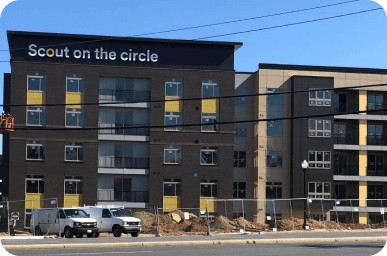 Scout on the Circle lettering and branded graphics on an apartment building facade.