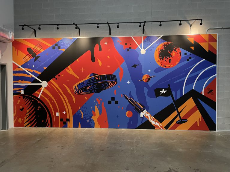 Bright geometric and abstract graphics covering an interior wall.