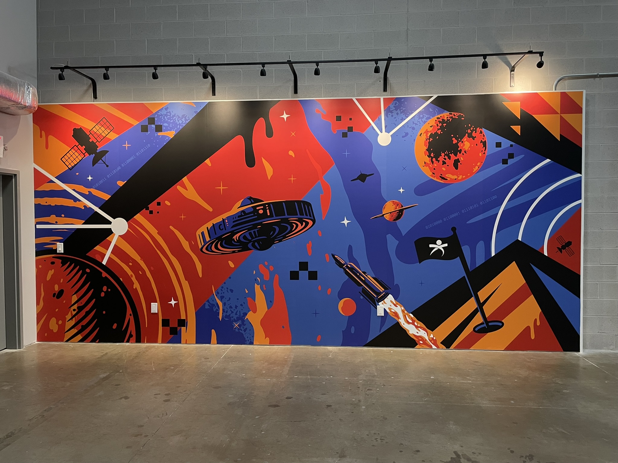 Bright geometric and abstract graphics covering an interior wall.