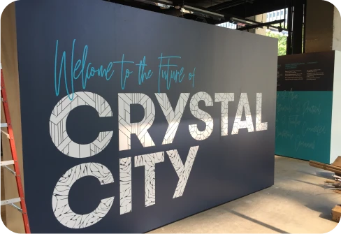Welcome to the New Crystal City lettering on an interior wall.