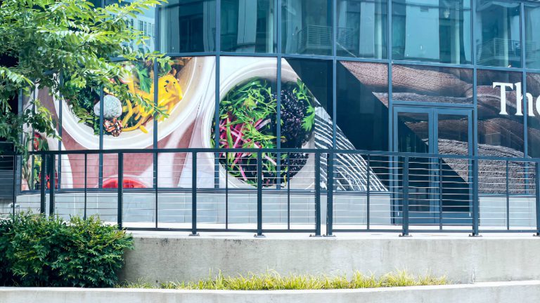Tropical plant graphics on the windows of a garage entrance.