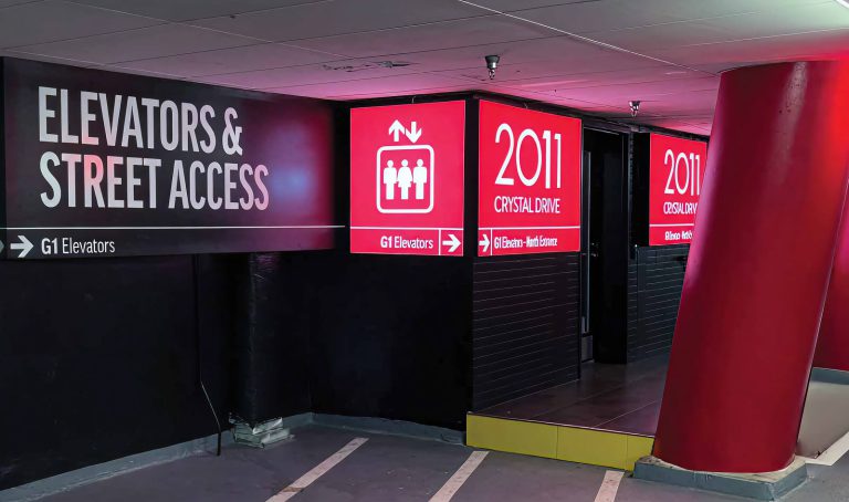 Elevator and street-access directions printed beside red garage level identifiers.