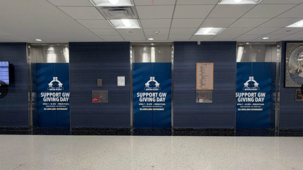 Blue George Washington University donor-recognition panels in an interior lobby.