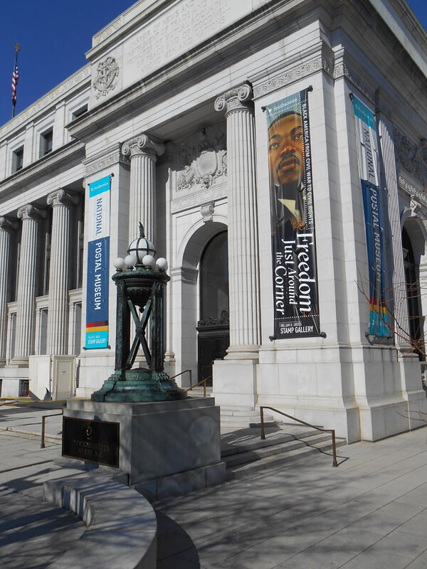 Exhibition banners mounted outside the National Postal Museum entrance.