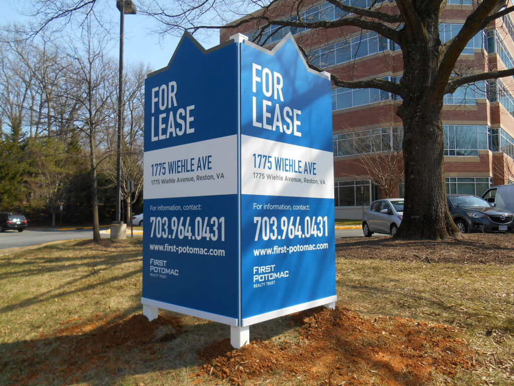 Blue For Lease signs beside an office building in Potomac.