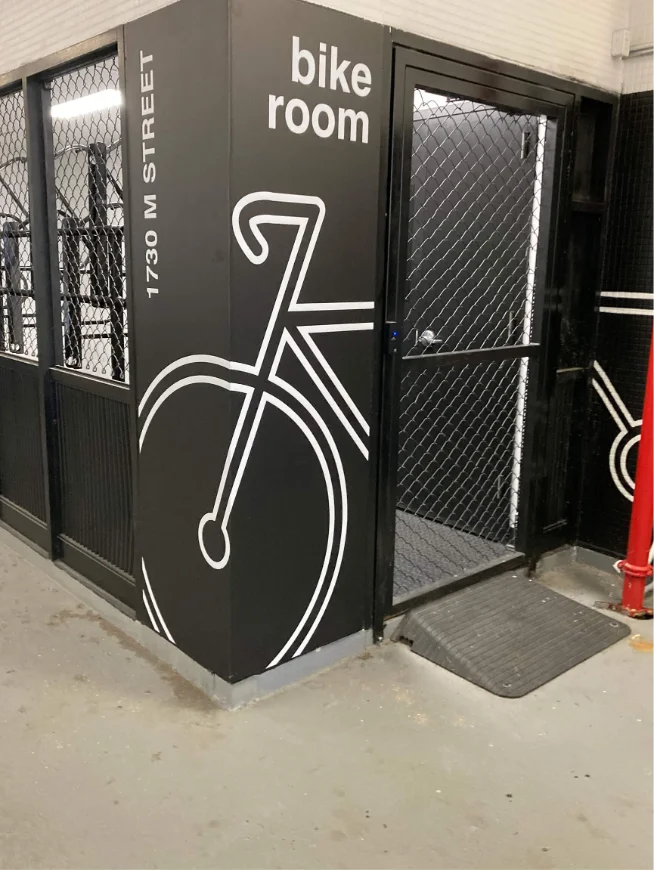 Bicycle room directional graphics printed on an interior wall.