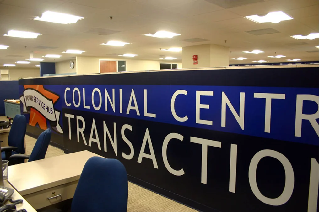 Colonial Central transaction counter with large blue and white lettering.
