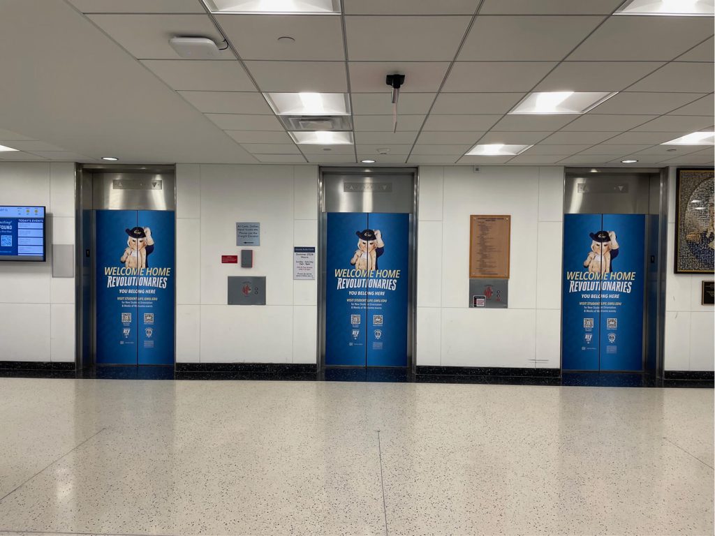 Blue George Washington University donor-recognition panels in an interior lobby.