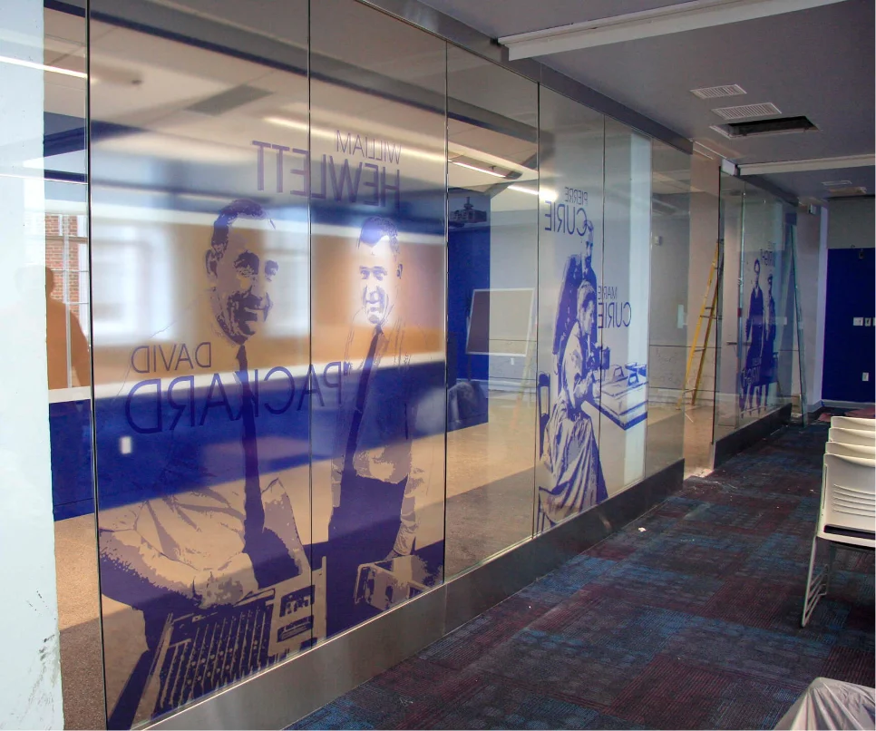 George Washington University graphics printed across glass partitions in an office corridor.