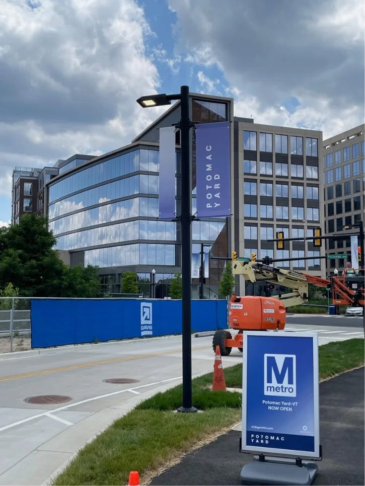 Metro station wayfinding sign beside an office building.
