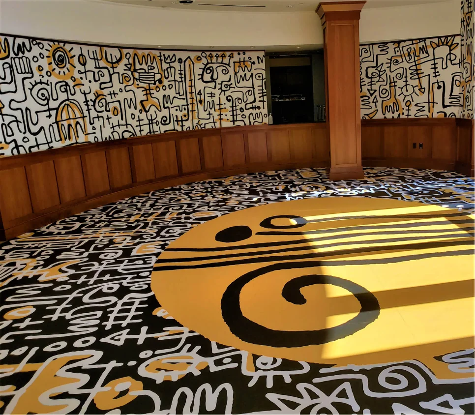 Illustrated floor and wall graphics surrounding a museum exhibit space.