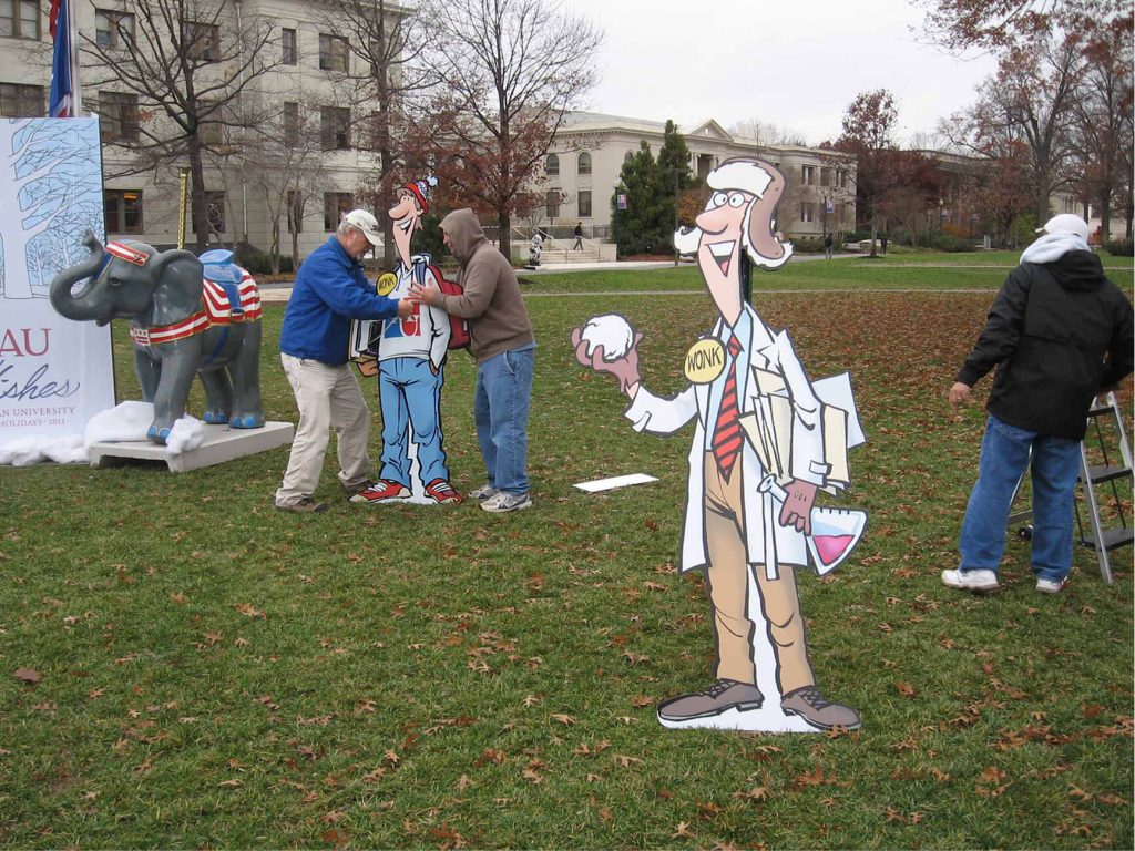 Printed character cutouts displayed at an outdoor community event.
