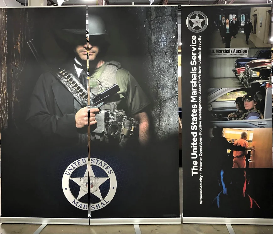 United States Marshals Service exhibit graphics featuring a historic law enforcement figure.